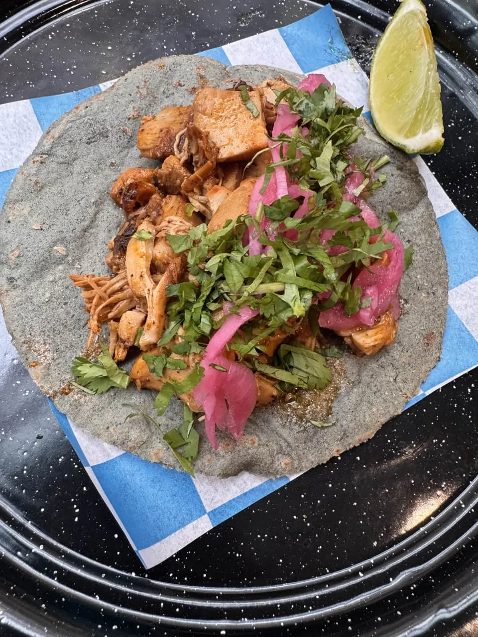 Pollo asado taco served with fresh toppings